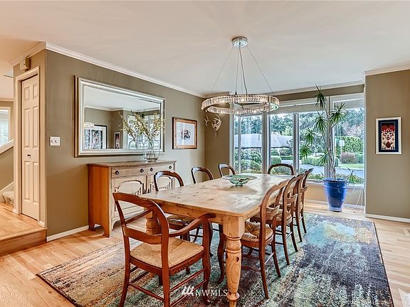 Stunning formal dining room is accented with a custom chandelier and an expanse of windows to let in the natural light.