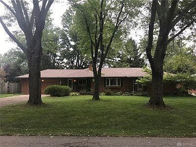 Quiet, tree-lined street. View of house.