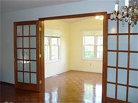 Paned French doors to the sunroom can be closed off for privacy or to create a quiet resting spot.