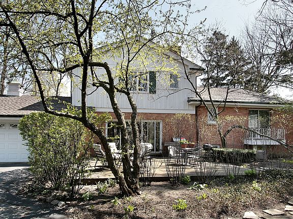 Rear view: 2.5 car gar., patio, balcony off 1st fl. master BR.