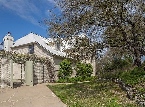 Wisteria covered patio-water friendly landscaping. Front lawn is all bluebonnets!