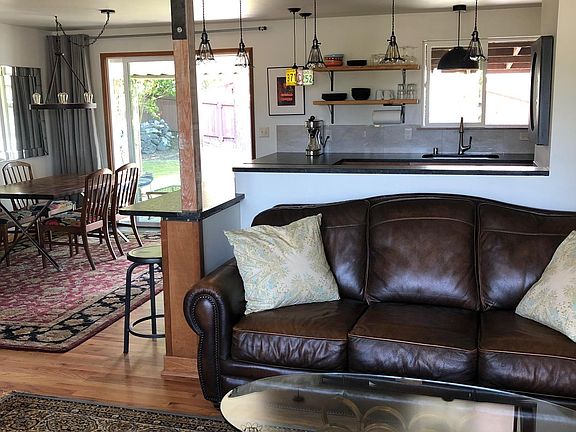 Looking from Living Room into Kitchen and Dining Area. Sliding Doors lead to backyard and covered patio area.