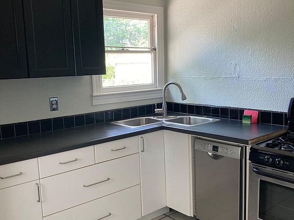 kitchen with stainless dishwasher, range and fridge