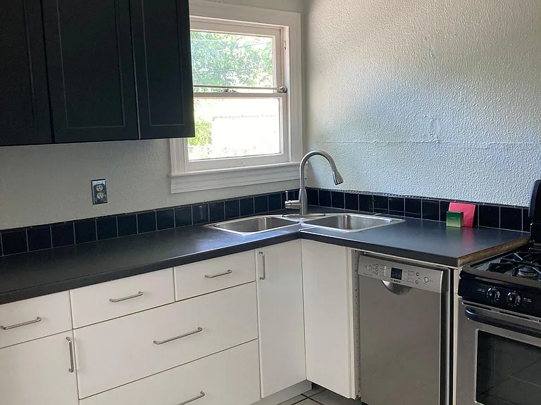kitchen with stainless dishwasher, range and fridge