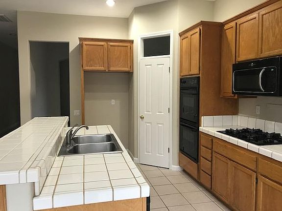 Kitchen with walk-in pantry, electric double ovens, built in gas range and microwave