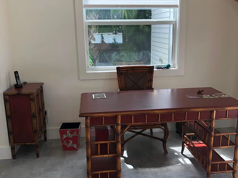 British colonial desk in sunroom.