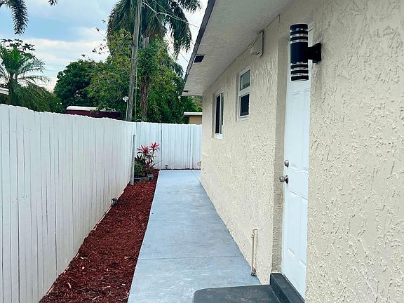 Side door (behind fence)