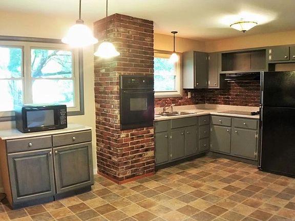 Large eat in kitchen with lots of texture. Appliances stay.