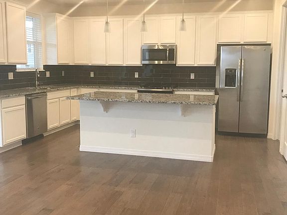 kitchen with slab granite ,white upgraded cabinets and stain