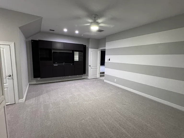 Large bonus room with built in entertainment center can be used as a media room or 5th bedroom