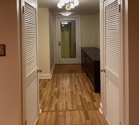 Entrance Hall. Storage in historic coal bins and two hall closets.