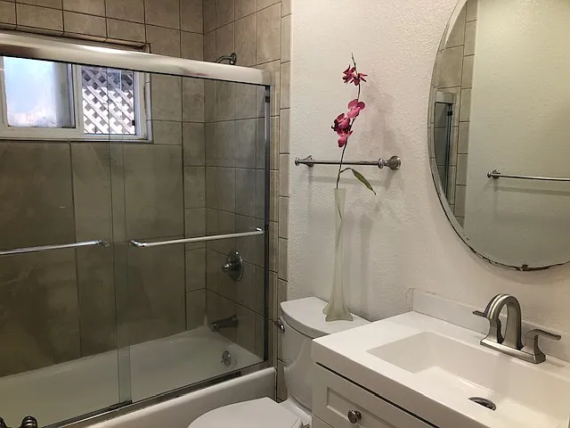 Hallway bathroom with a tub. New vanity with new sink, new water fixture, and new potty