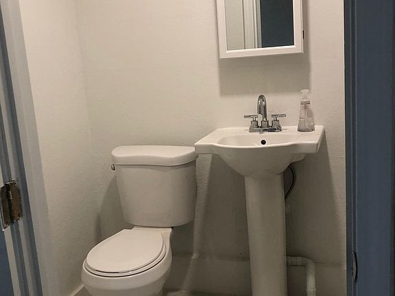 Bathroom (new floor tiling, toilet, and sink)