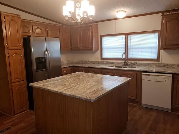 Side by side refrigerator and oak cabinetry