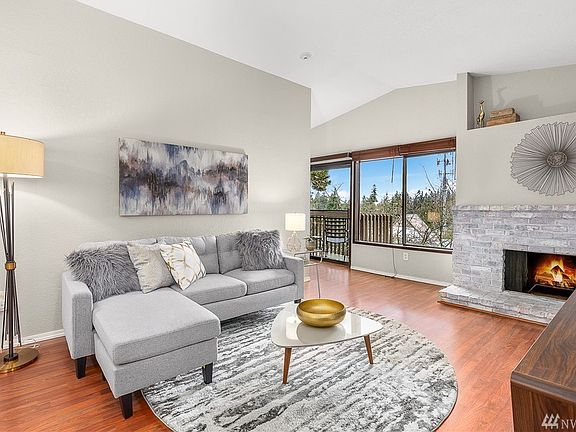 Spacious living room with wood-burning fireplace.