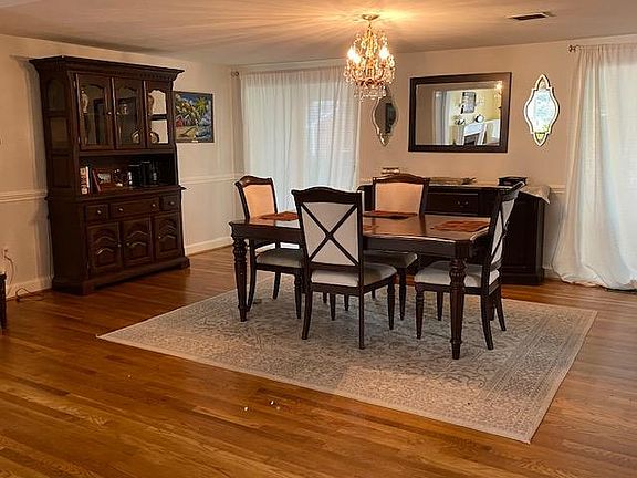 Formal dining room with chair rail and double-set of full-length windows.