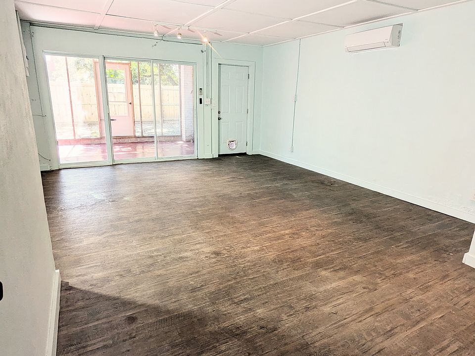 Large living space opens up to floor to ceiling windows overlooking your private, screened in porch and fenced in yard.