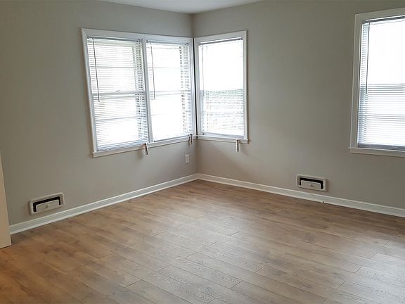 Spacious living room with new laminate hardwood, fresh paint, and plenty of natural light!
