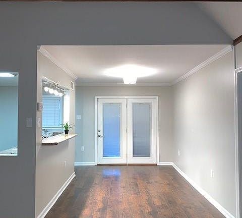 Dining Room with NEW WOOD Laminate Flooring. Counter for Bar Stools. Exterior doors leading to the back patio features inside-the-glass blinds for dust free performance. Fresh Paint: Sherwin Williams Agreeable Grey