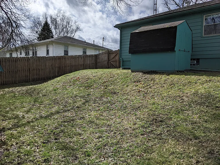 Fenced in back yard and storage barn