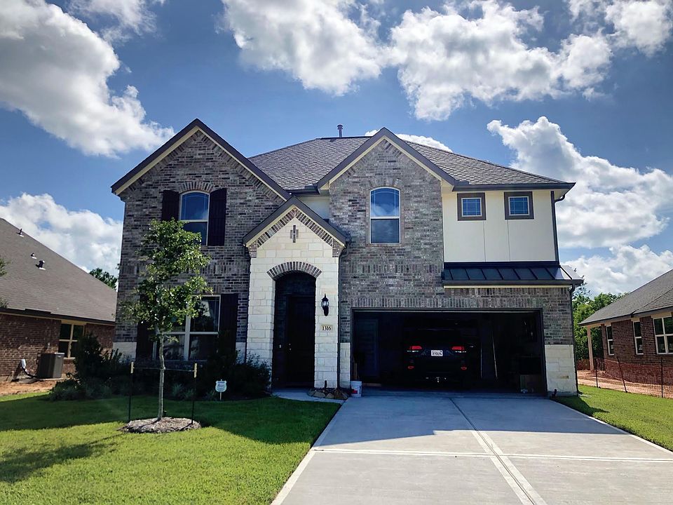 Beautiful front of the house with a 2 car garage and large driveway