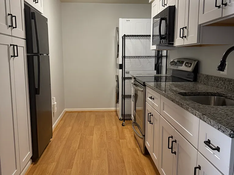 Kitchen with brand new, full size, LG washer & dryer.