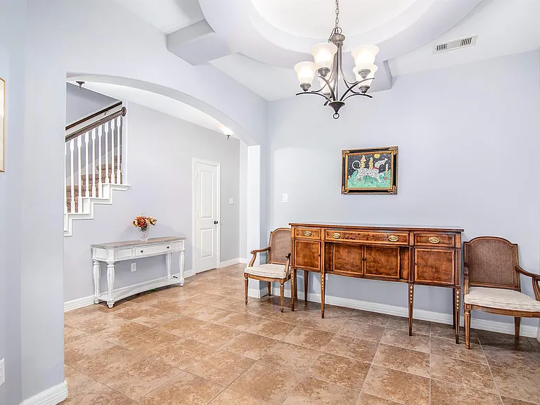 Elegant ceiling detail creates a bright and inviting dining space or living space