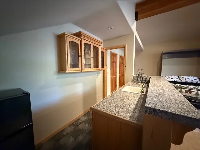 Wet bar in gameroom/bedroom with dorm refrigerator