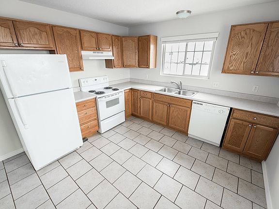 Tiled kitchen with plenty of cabinet/counter space. 
