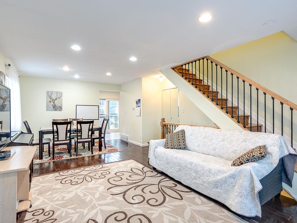 Living room with a lot of sunshine, hardwood floors.