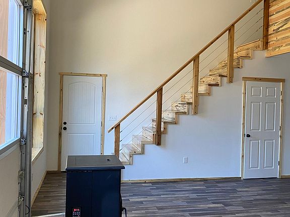 View of entrance and laundry room under stairs.