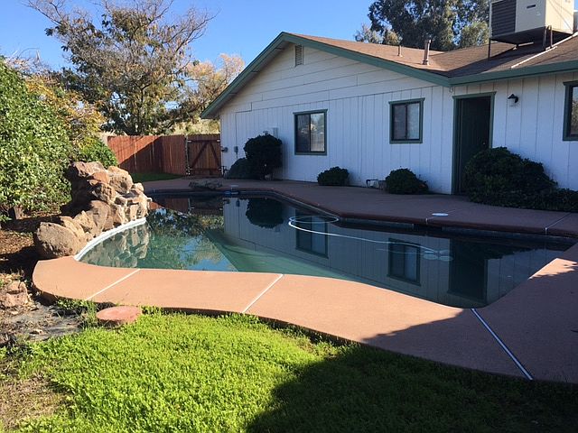 Back of house with pool