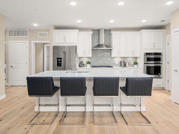 Gourmet Kitchen with Quartz Countertops, Hardwood Flooring and Stainless Steel Appliances