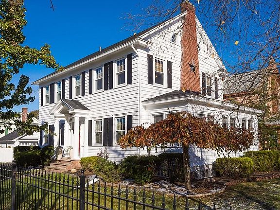 Corner lot affords charming views of home from Kline and Wendell Terrace.  White stockade fencing on far end of property.
