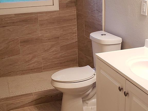 Bath has all new tile flooring, new shower, new toilet, sink, and hardware.