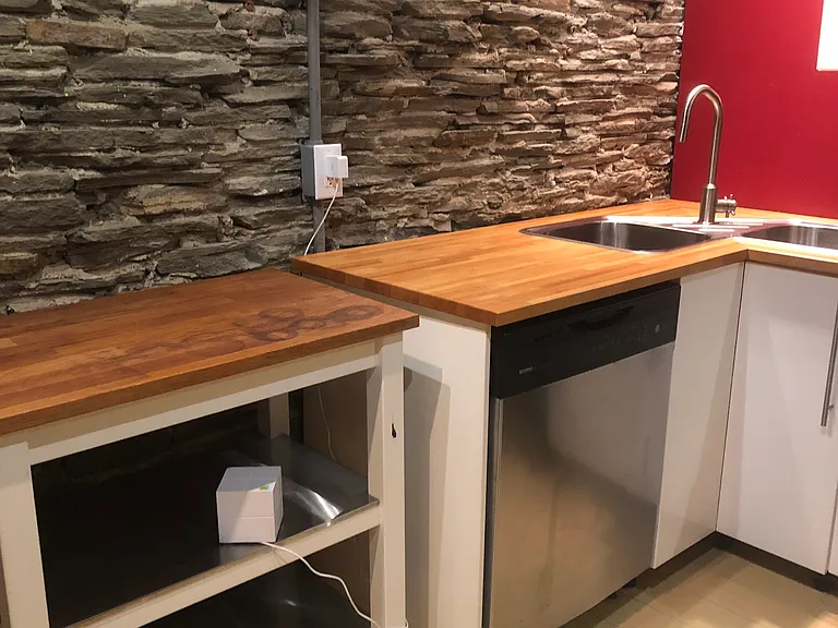 a closer look at the dishwasher and corner sink - the rolling island comes with the apartment to give you more counter space