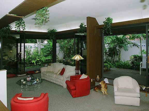 Great room with 10' ceilings looks out on pond and gardens thru glass doors