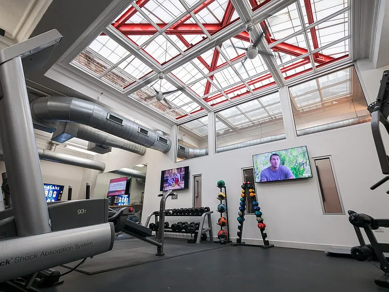 63 E Lake Apartments Fitness Center with strength training equipment