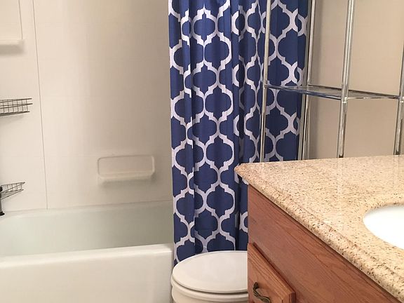 Neutral colors and bright bathroom. Granite top vanity