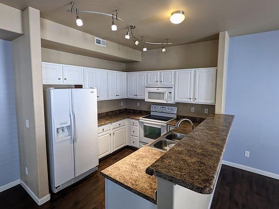 Kitchen with bat counter, track lighting.