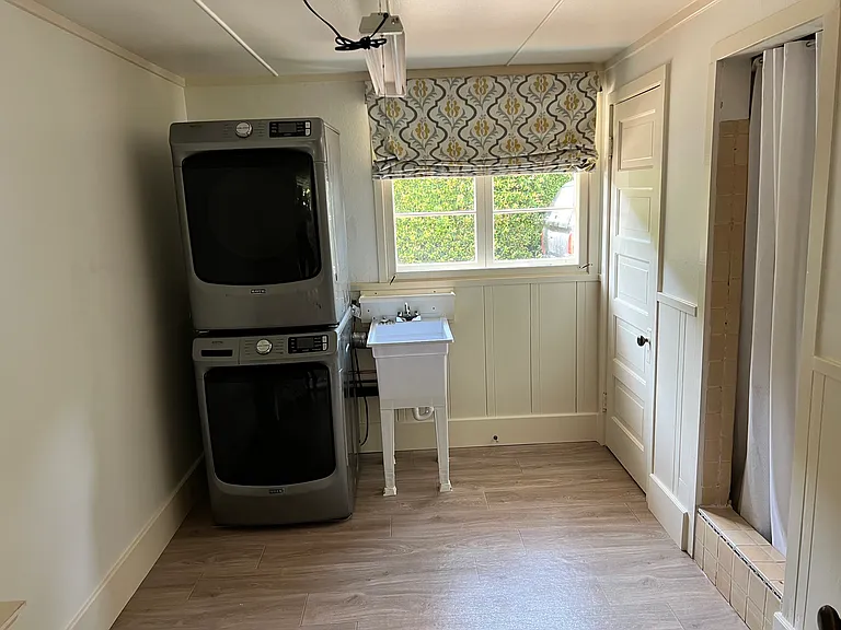 Dedicated laundry and half bath located in the walk-out basement adjacent to the workshop.