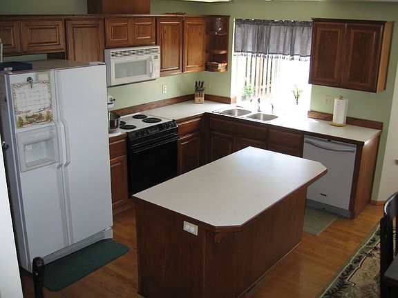 Large kitchen with island and oak cabinets.