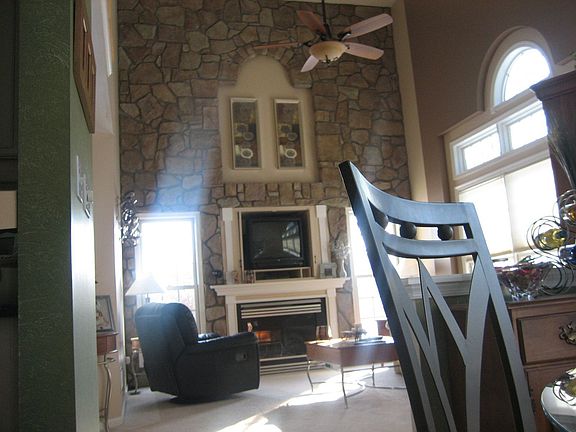 Two-Story Family Room w/Stone Wall & Gas Fireplace