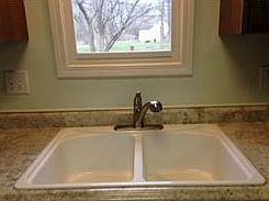 Large porcelain double sink with window overlooking the back yard.