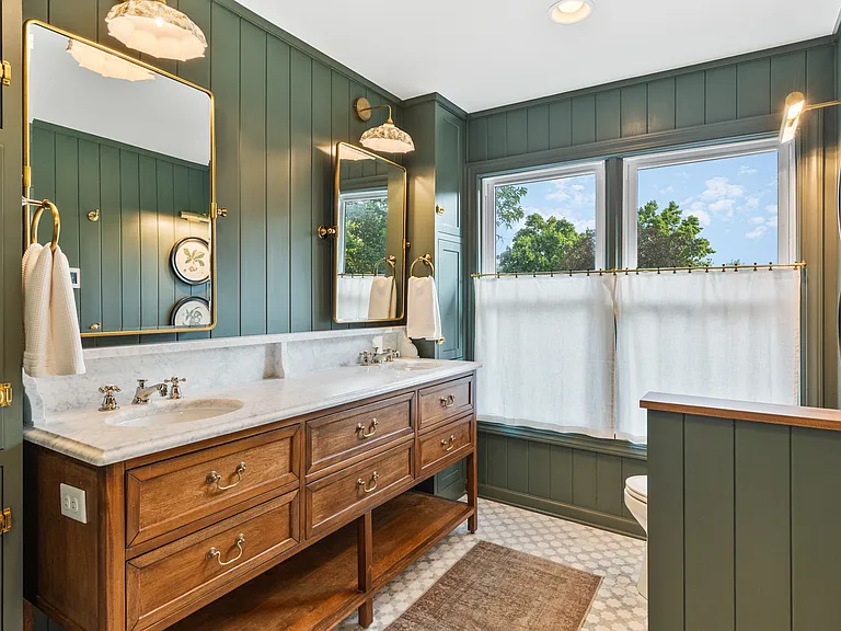 Beautiful primary bathroom attached to bedroom #1. Enjoy a spacious double vanity, huge standing shower, and lots of natural light.