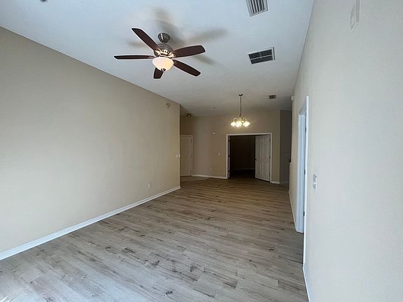 living room with extra bonus room entrance