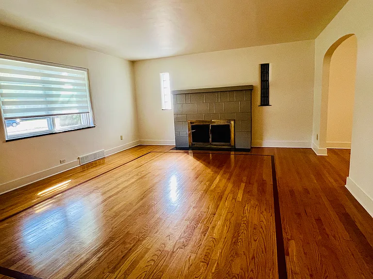 Main floor living room with wood burning fireplace