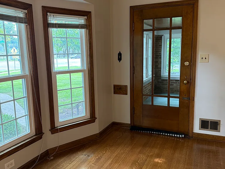 Living room with door exiting to 3 seasons room