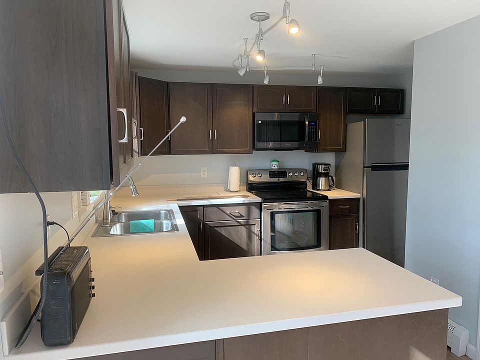 Kitchen with stainless steel appliances including coffee maker.