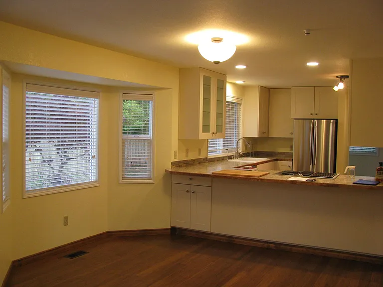 Eat in kitchen bar and bay window nook for dining or desk, faux wood blinds
